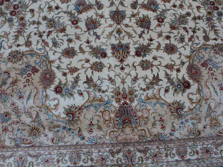 white field on Tabriz silk rug